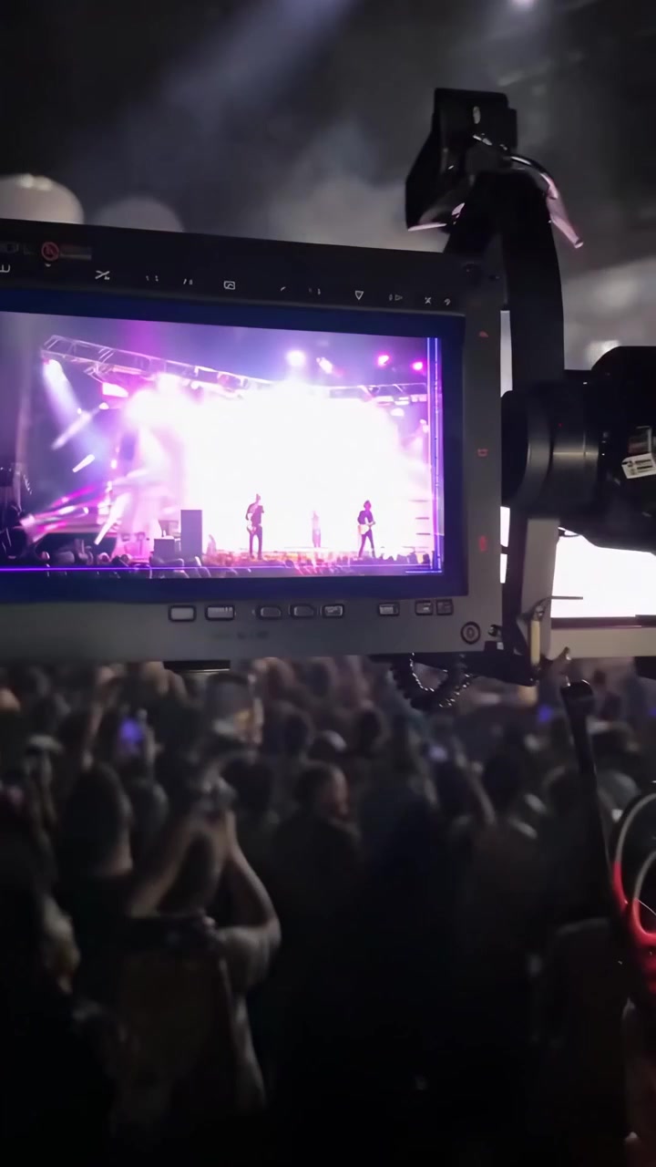 Videographer Filming a Live Music Concert Performance