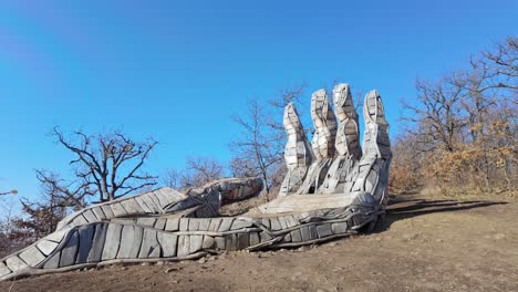 wide shot of palm of god wooden tourist attraction during the day near holloko, hungary.