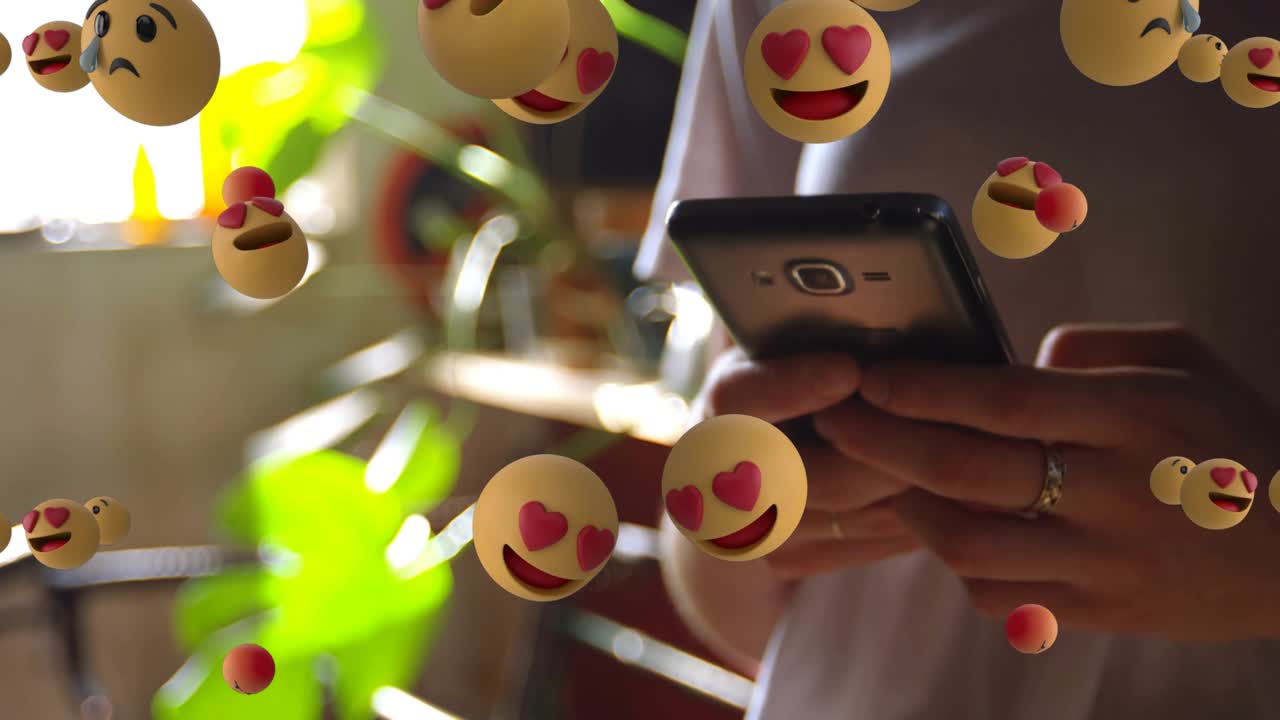Woman holding smartphone tapping screen, causing emoji cloud multiplying and dispersing for ads
