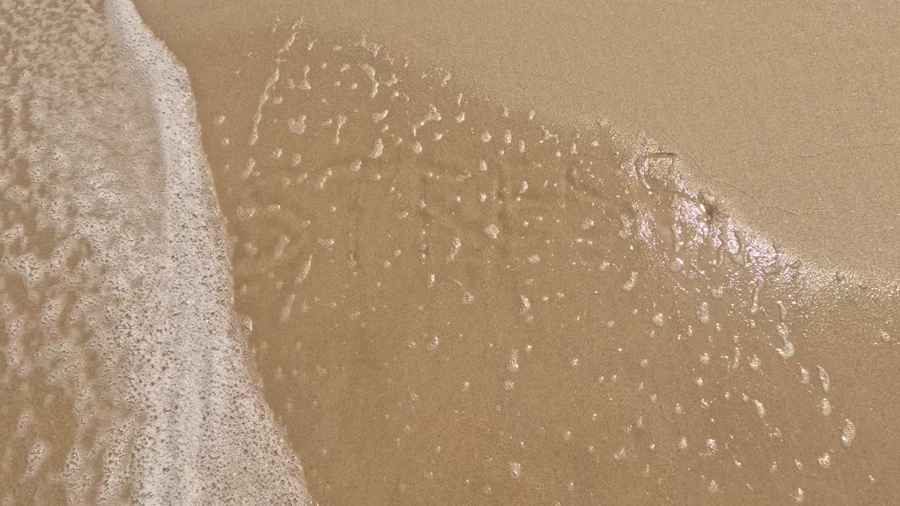 &amp;quot;Stress&amp;quot; word is written on the beach sand and erased with a wave, a concept video of relaxation and stress relief