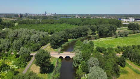 Aerial-drone-shot-above-a-nature-park,-water-canal,-abandoned-kastel-of-Almere-city,-province-Flevoland,-Netherlands