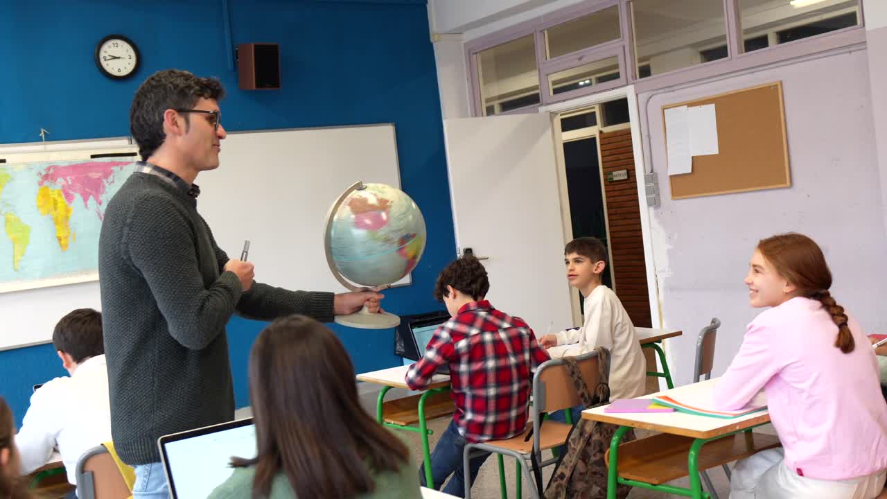 Teacher explaining geography with a globe in the classroom
