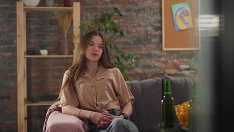 brunette lady sports fan watches hockey match in living room