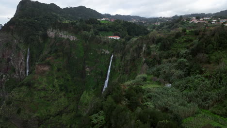 aerial view of waterfalls flowing down the mountain cliff in rocha do navio, madeira island, portugal