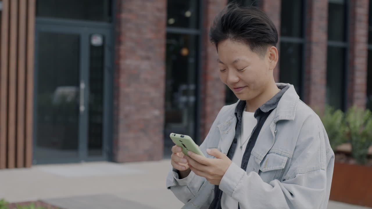 Young Person Using Smartphone Outside