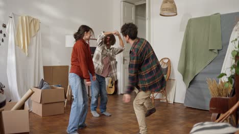friends dancing in a new apartment