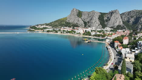 aerial views over omis with cars driving along the coastline, croatia