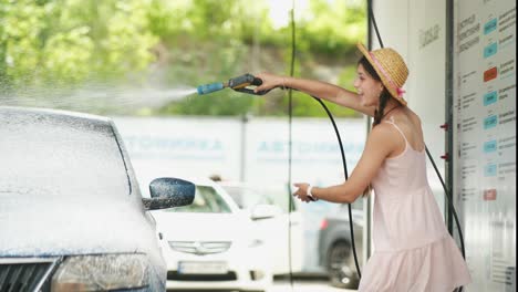 young woman enjoying a car wash