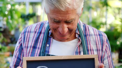 Mature-man-holding-open-sign