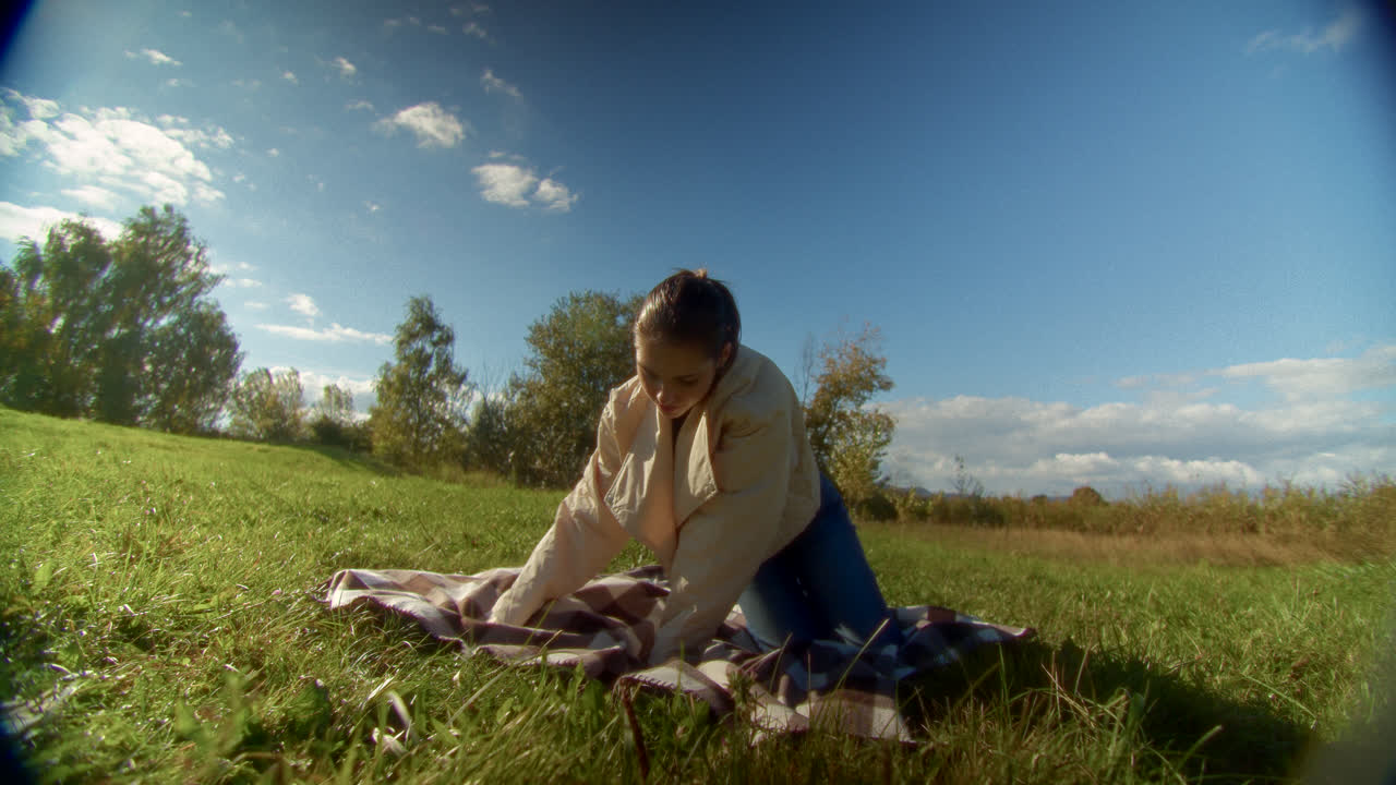 Woman relaxing on a blanket in a park