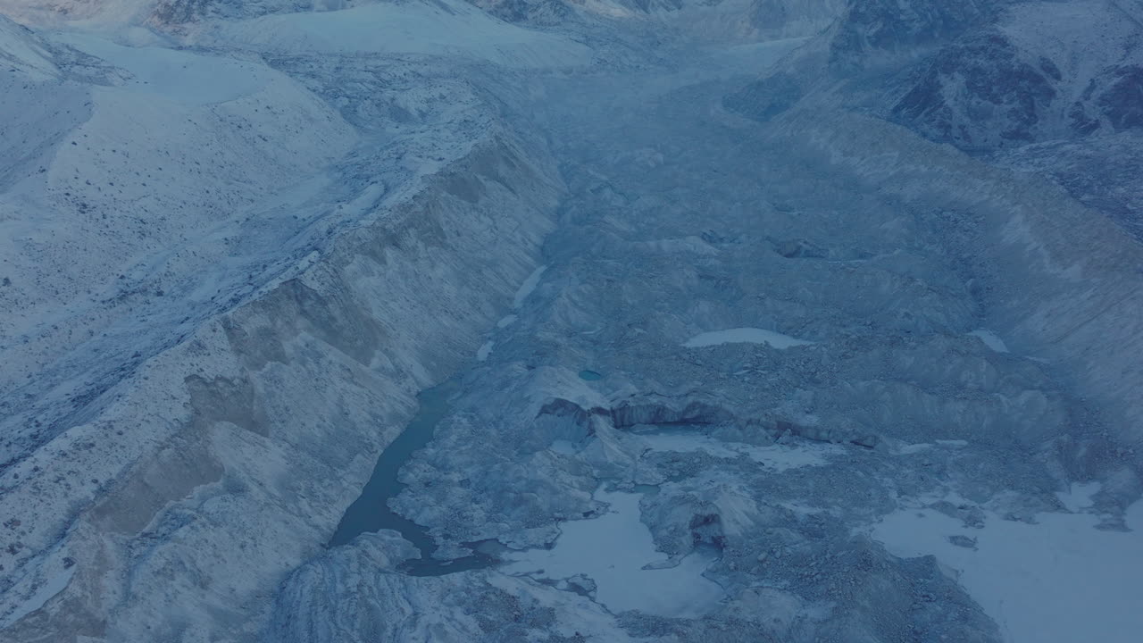 Close-up aerial shot reveal Everest Base Camp trek in Khumbu, Nepal. Morning snowfall uncovers Mount Pumori, Lobuche, and Nuptse peaks in Himalayas, a stunning highland view for adventure tourism