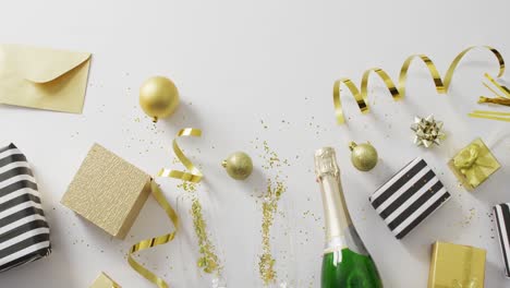 decorations and champagne on white background at new year's eve