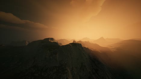 High mountain peaks covered with dramatic heavy fog