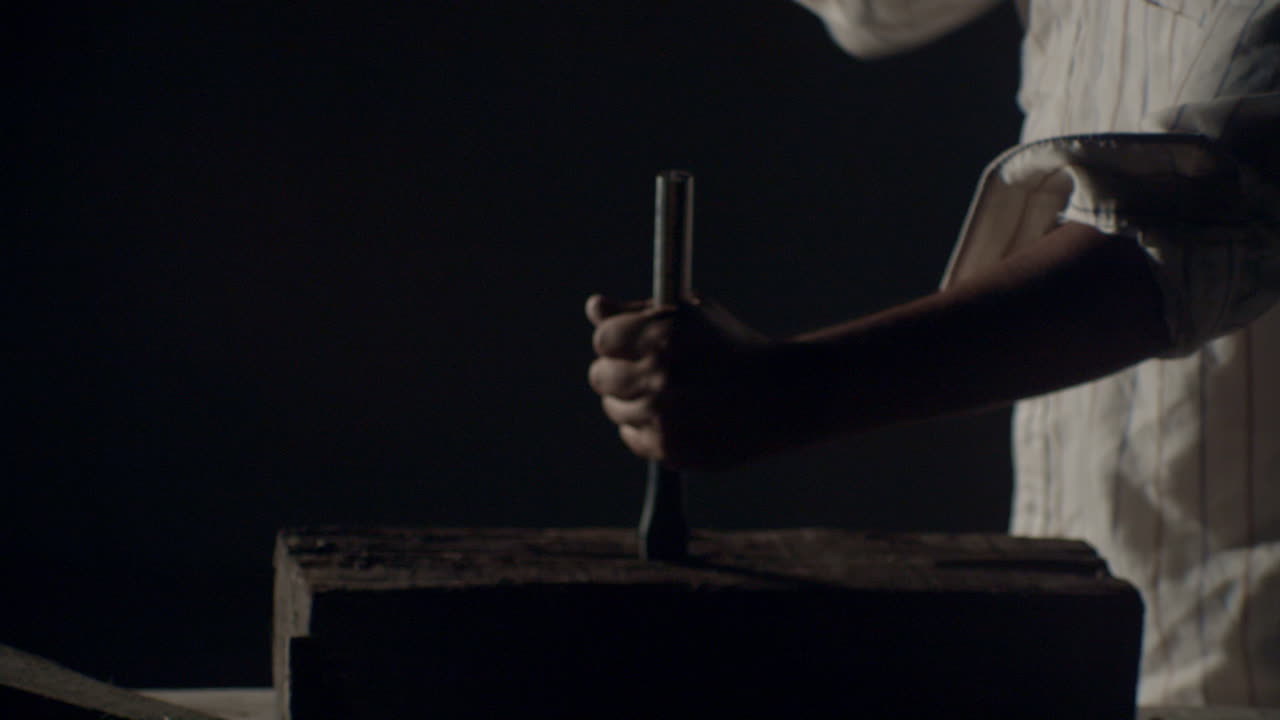 Hammer hitting a big nail in a dramatic misty ambience