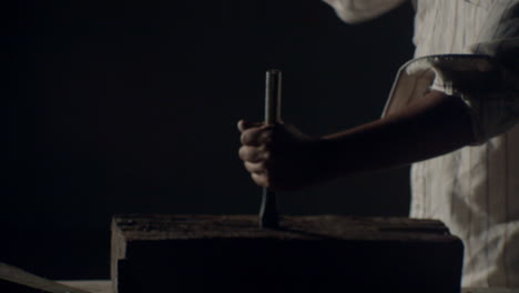 hammer hitting a big nail in a dramatic misty ambience