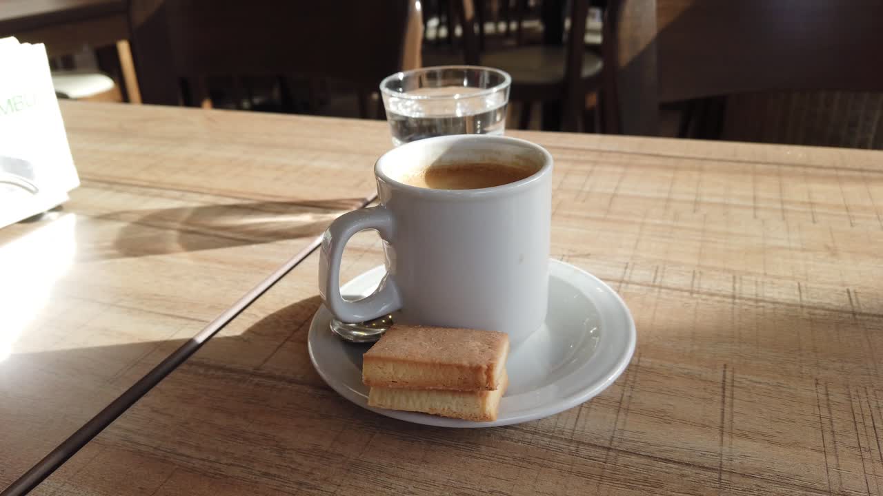 Morning Espresso with Biscuits on Italian Restaurant Table in Natural Light – Close Up View