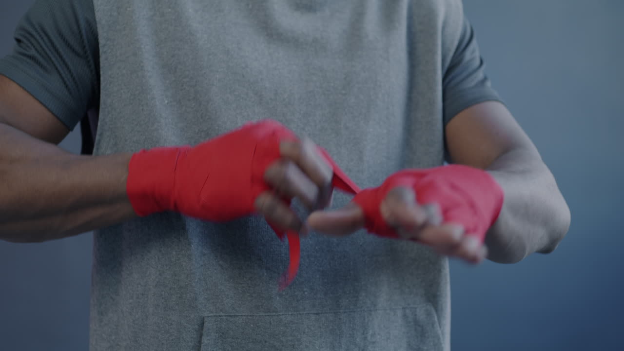 Man putting on boxing wraps
