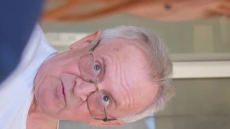 a cardiologist consults an elderly man in a clinic. heart diseases. 4k video