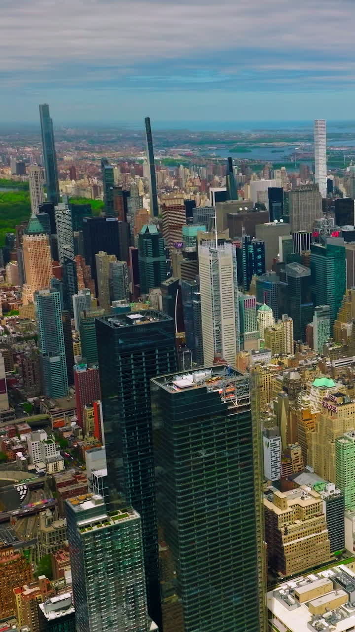 Scenic view on the stunning architecture of New York. Fabulous skyscrapers stand out at the backdrop of beautiful cloudy sky. Vertical video
