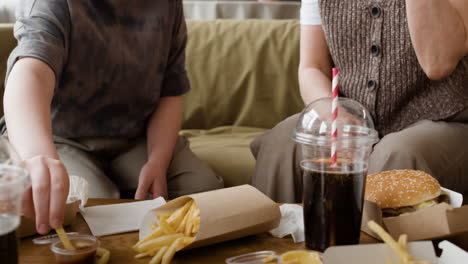 people enjoying fast food at home