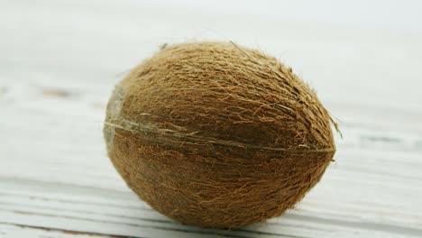 Unpeeled-brown-coconut-on-table