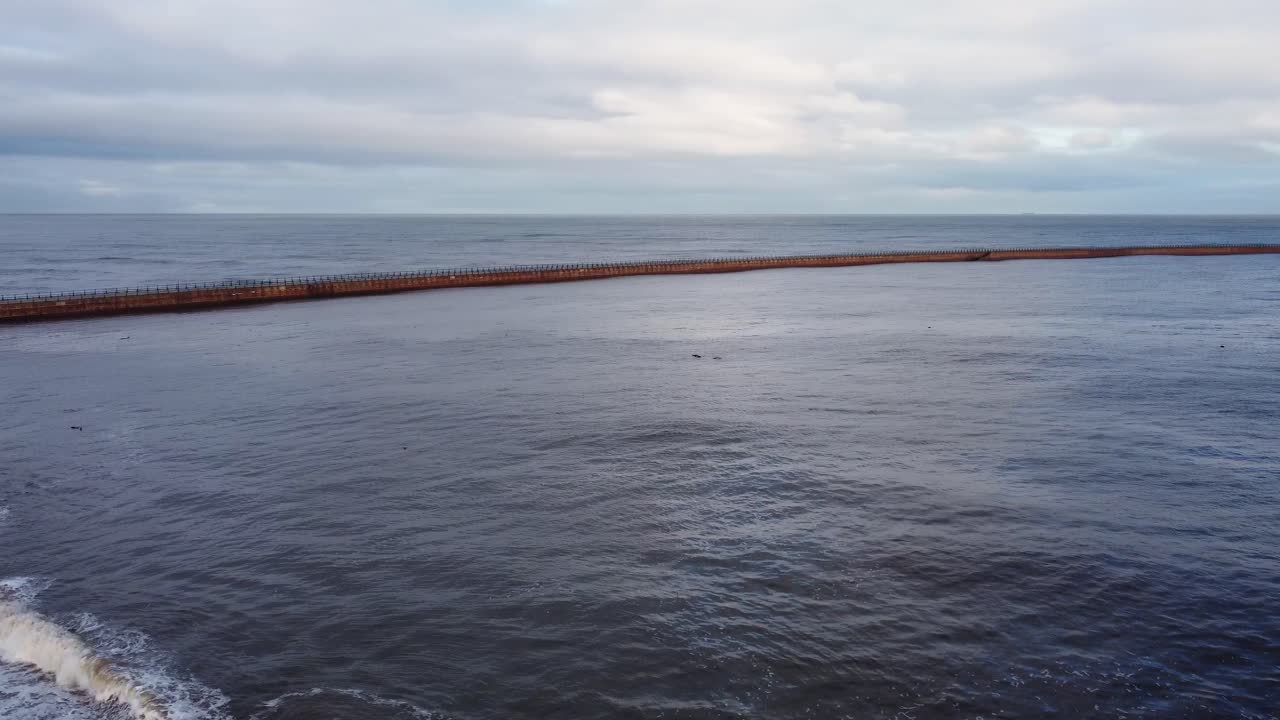 Aerial of Roker beach and pier leading to lighthouse