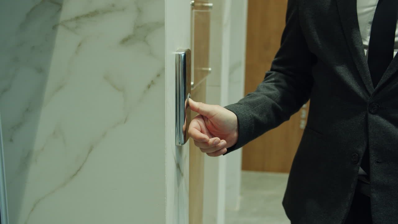 Businessman Pressing Elevator Button