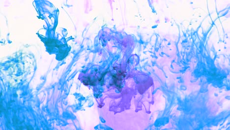 4k footage of colorful ink drops in water, isolated abstract background. pouring ink in water. underwater paint mix. slow psychedelic dye swirls, colored smoke explosion. splashing, floating liquid