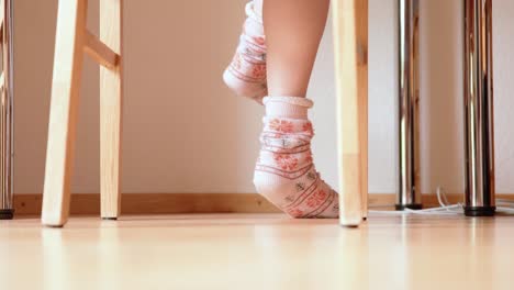 concentrated feet jiggling under table in warm christmas socks