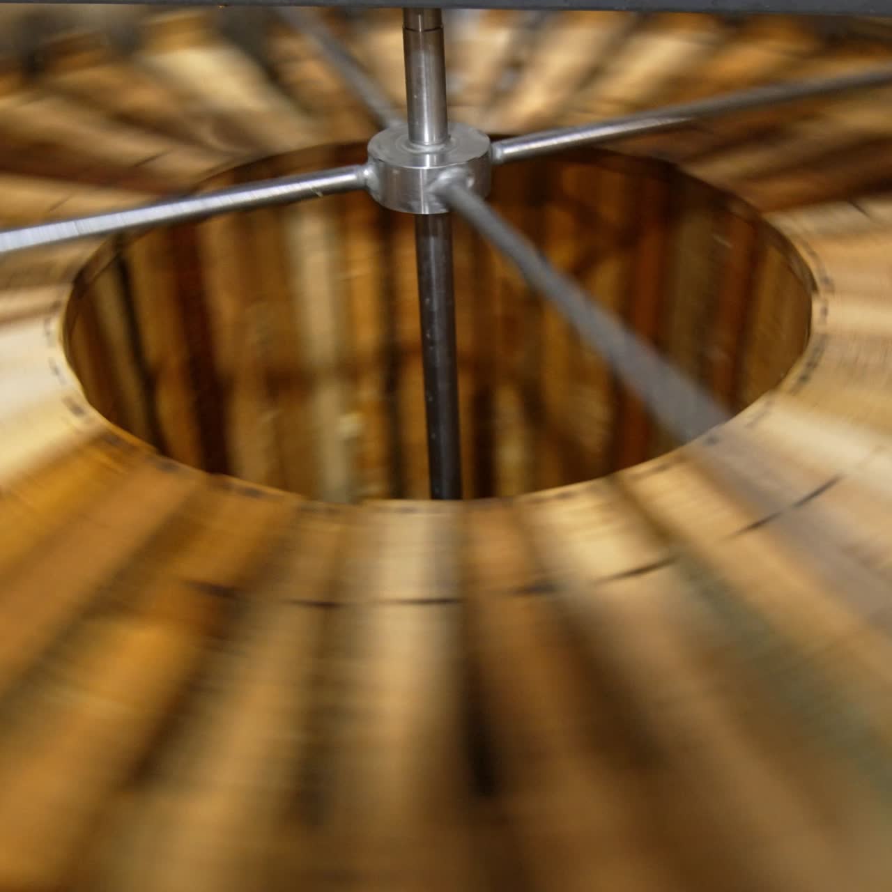 Process of honey extraction in the electric centrifuge device. Many wooden frames are rotated for taking honey out of cells