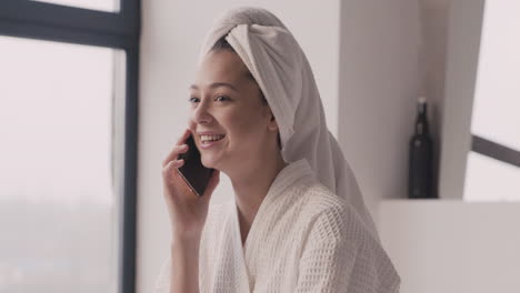 Woman-In-Bathrope-With-A-Towel-In-Her-Head-Talking-On-The-Phone