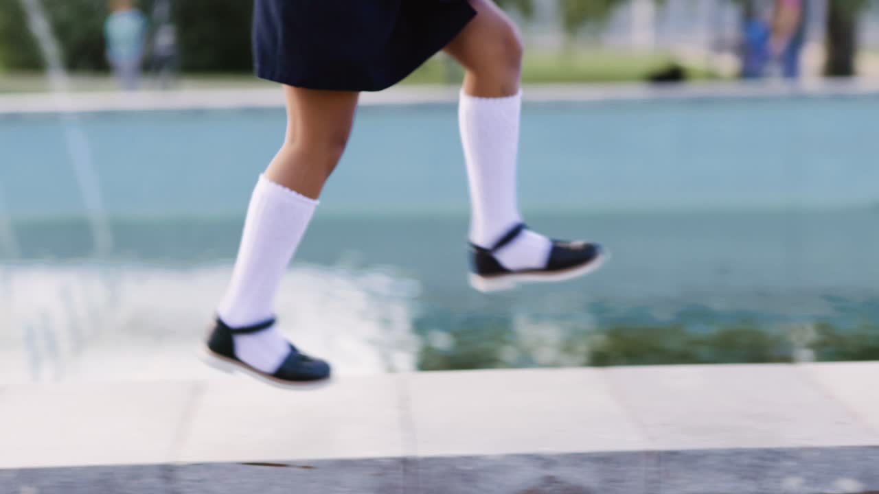 Schoolgirl Jumping Near Fountain
