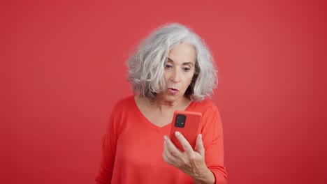 Surprised Senior Woman Looking at Phone
