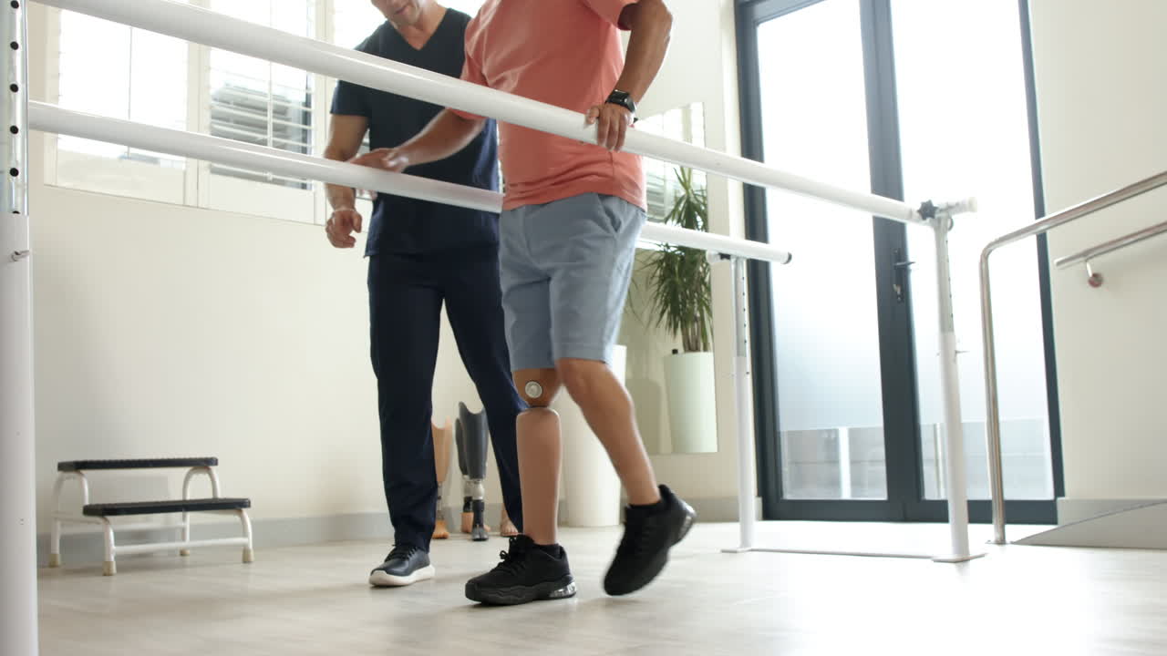 Walking with prosthetic leg, child receiving therapy in rehabilitation center