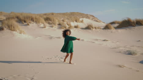 dancer performing summer desert alone. curly girl dance sand beach mesmerizingly