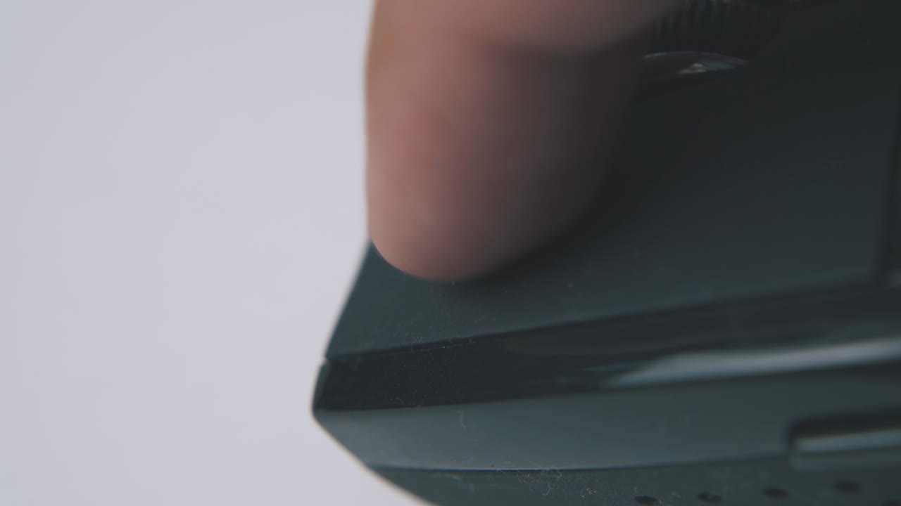 person uses computer mouse with wheel on white surface