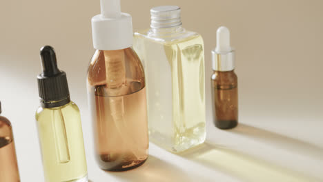 Close-up-of-glass-bottles-with-pumps-with-copy-space-on-grey-background