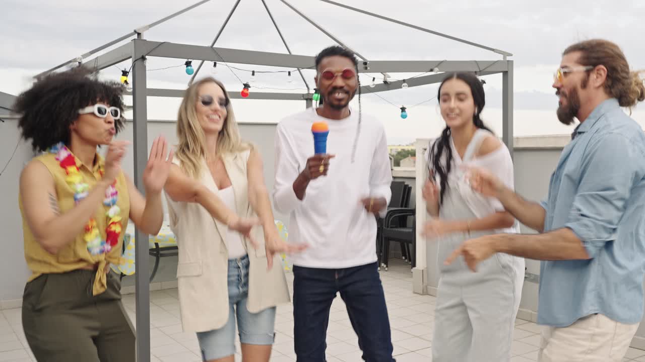 Group of Diverse Friends Enjoying a Rooftop Karaoke Party