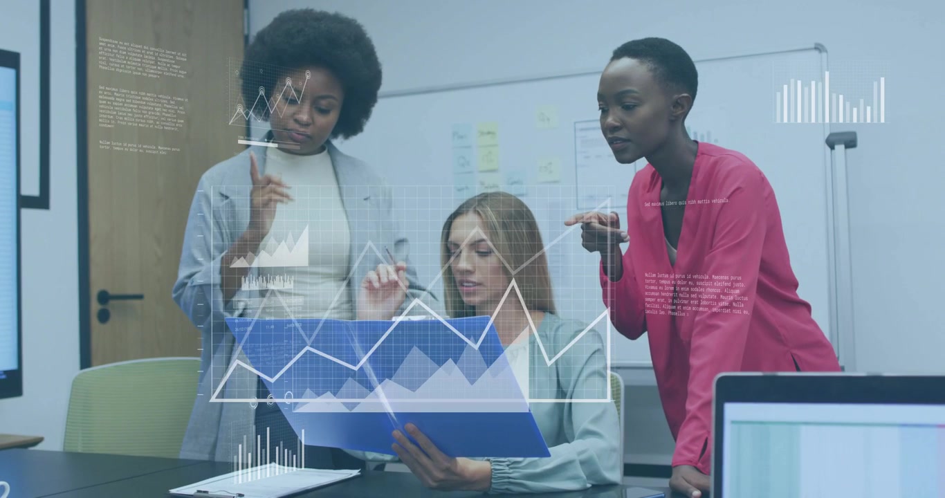 Three women leaning over blue file seated peer turning pages reading causing motion finance charts