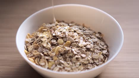 Pouring-honey-onto-cereal-in-a-bowl