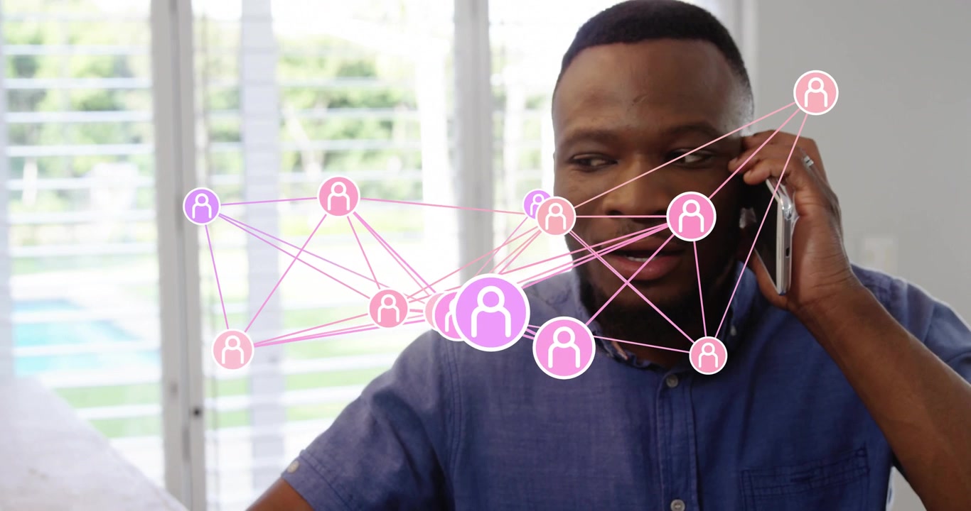 Man lifting phone, speaking while network overlay shifting across chest shows business teamwork