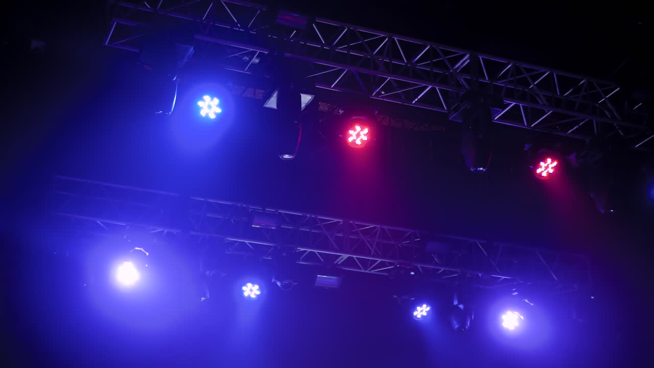Colorful bright concert lighting equipment for stage at nightclub