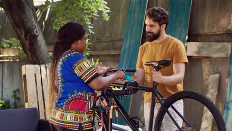 couple adjusts bicycle on repair-stand