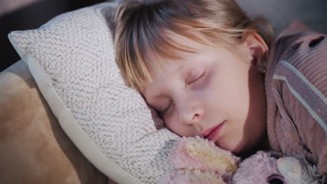 a girl sleeps with her favorite plush toy