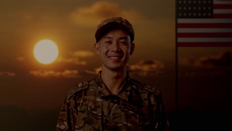 close up of asian man soldier standing and smiling to camera with flag of the united states, sunset time