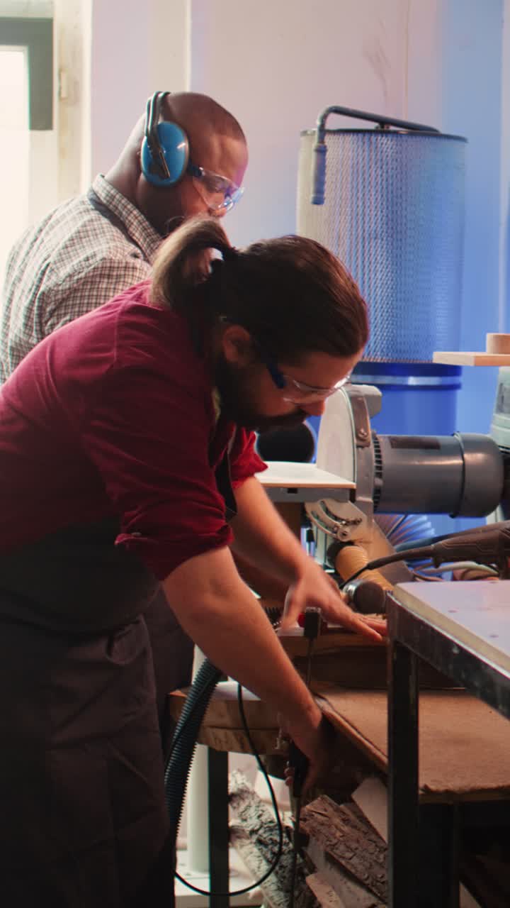 Two Woodworkers Crafting and Sanding Wood in a Workshop