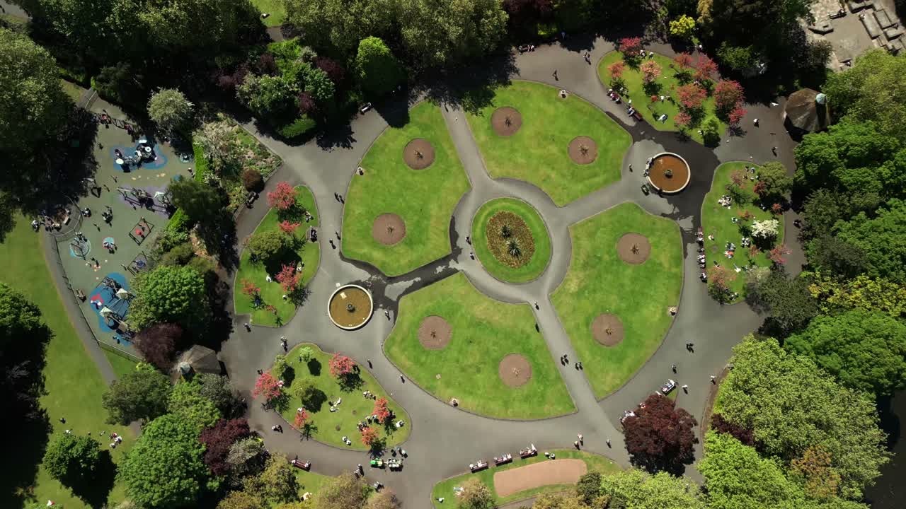 Advancing overhead aerial video of St Stephen's Green in Dublin City Centre, County Leinster, Ireland, on a bright and sunny day. Produced in 4K, 60FPS and with Rec709 color.