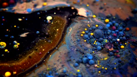 abstract colorful acrylic and food paint bubbles on water