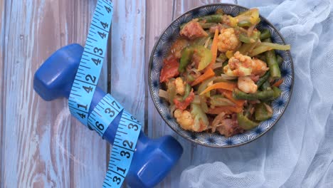 healthy vegetable dish with fitness accessories