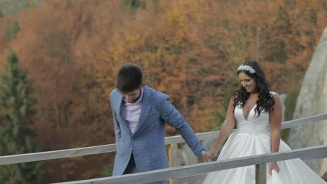 Groom-with-bride-on-a-bringe-near-mountain-hills-in-the-forest.-Wedding-couple